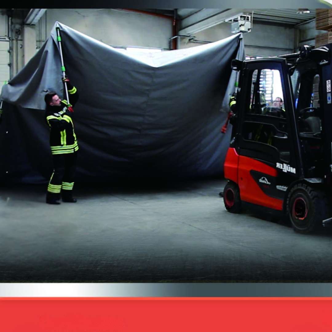 fire blanket being lifted with telescopic poles to cover electric forklift